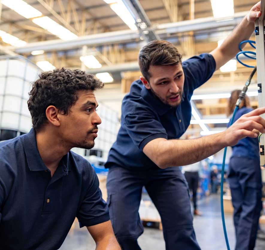 Two young men work in a warehouse